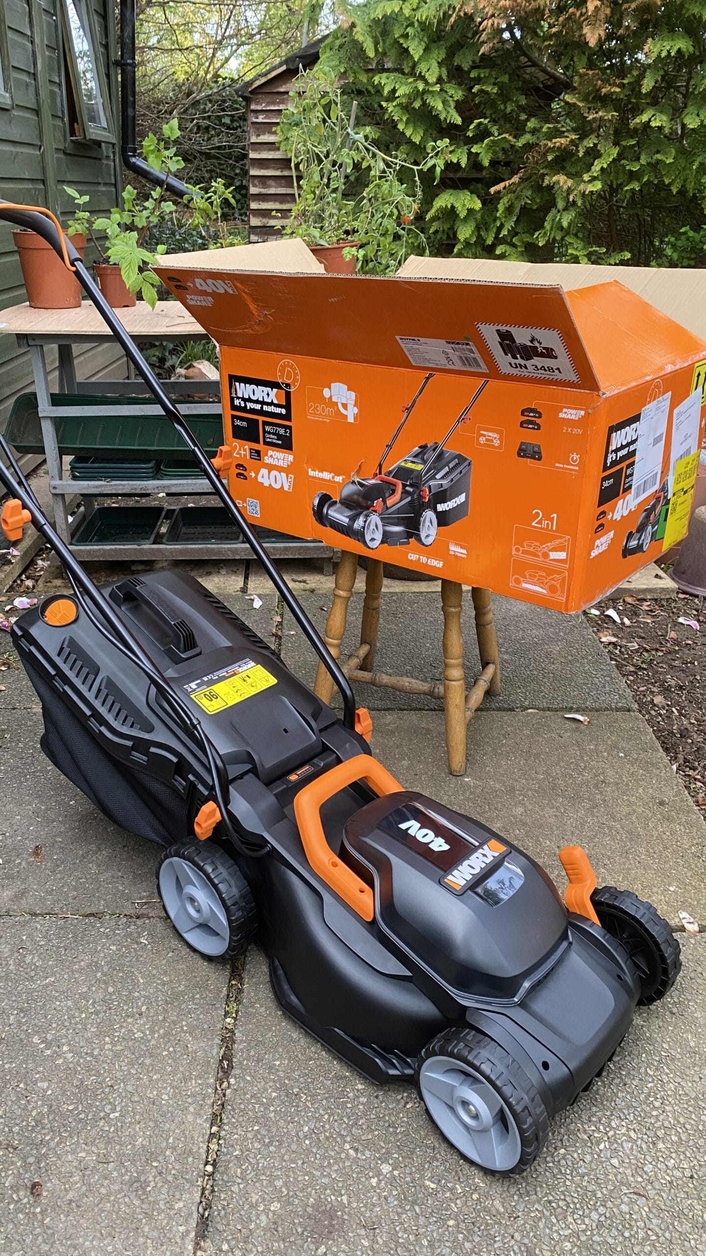 Worx WG779E cordless lawn mower unboxed with dual 20V batteries and orange packaging