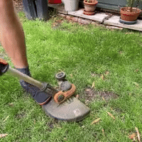 User pushing WORX WG163E head back into edging mode by stepping near the shaft and applying downward pressure