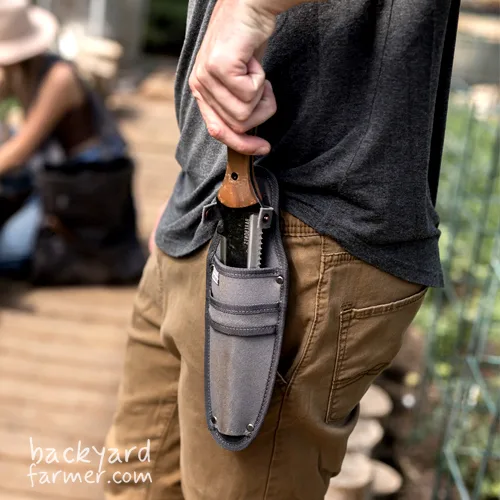 a sheathed hori hori knife