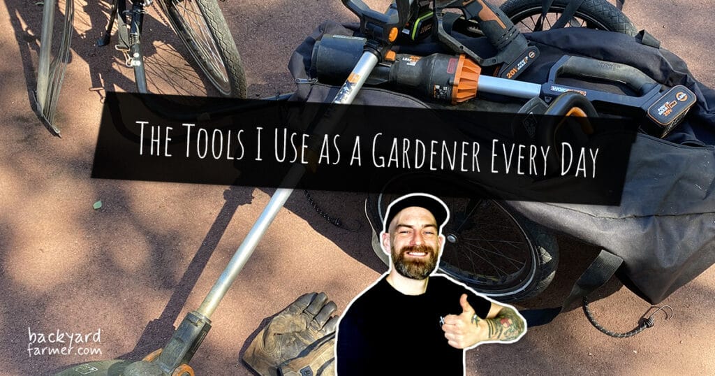 Essential gardening tools on a bicycle trailer including secateurs, Hori Hori knife, and cordless power tools used by professional UK gardener